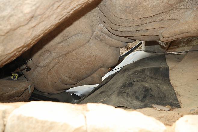 A photo of a fallen down rock-carved Buddha statue in Gyeongju, North Gyeongsang Province, taken in 2021 (Jogye Order of Korean Buddhism)