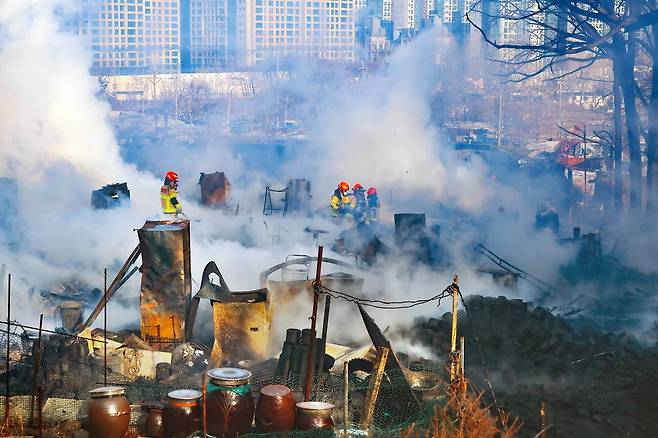 20일 오전 화재가 발생한 서울 강남구 개포동 구룡마을에서 소방대원들이 진화 작업을 하고 있다. 이날 화재로 인명 피해는 발생하지 않았지만 주민 500여 명이 대피했다.  <이충우 기자>