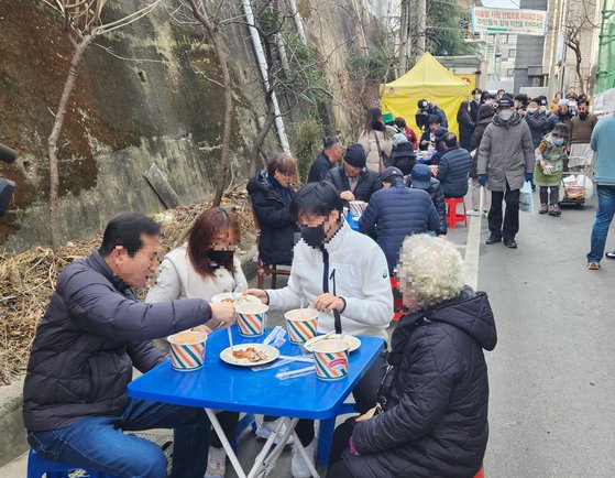2일 오후 대구 북구 대현동 경북대학교 서문 인근 골목가에서 돼지고기 수육과 소고기국밥을 받은 사람들이 식사를 하고 있다. 이날 돼지고기 잔치는 이슬람 사원 건립을 반대하는 대현동 주민 중 일부가 주최했다. 김정석 기자