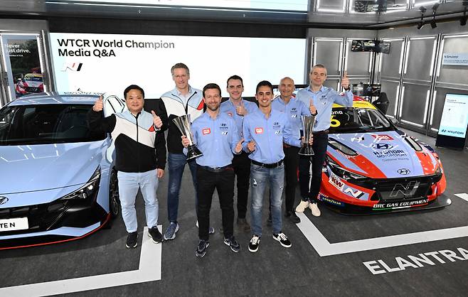 Mikel Azcona (front row, right), the champion of the 2022 World Touring Car Cup, poses with privious title winners and Hyundai Motor Group's N Brand executives at a press conference held in Seoul on Wednesday. (Hyundai Motor Group)