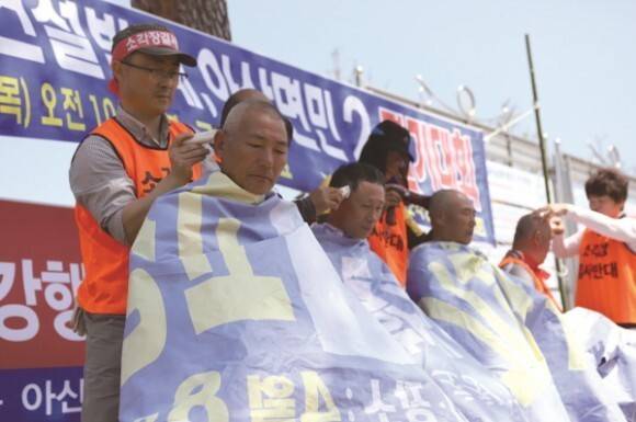 2019년 4월18일 고창군청 앞 아산면 소각장 반대대책위원회 출범식 모습. 맨 왼쪽에 서 있는 윤종호씨가 장기윤씨의 머리를 잘라주고 있다. 반대대책위 제공