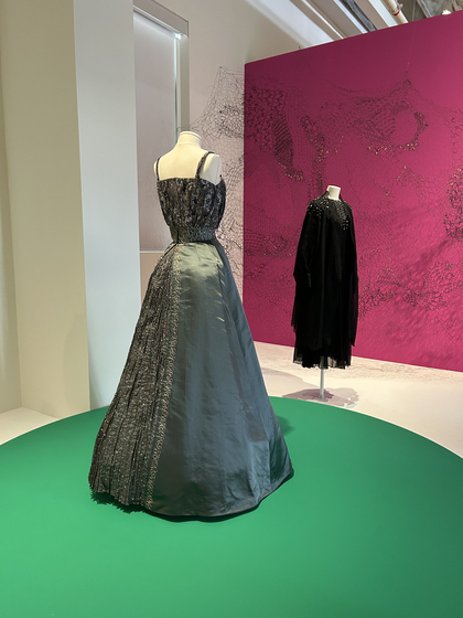 Choi Kyung-ja’s 1963 spaghetti strap crop top and flared skirt, left, and André Kim's 1985 dress ensemble of organza, chiffon and beading. Surrounding the dresses is Kim Kye-ok's "Second Skin" (2019). [SHIN MIN-HEE]