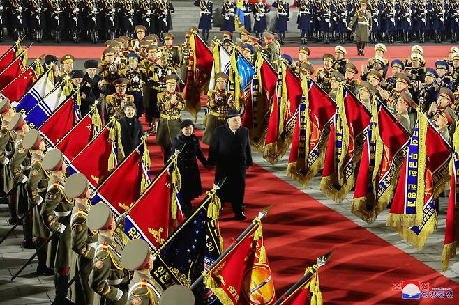 North Korean leader Kim Jong-un’s daughter, Kim Ju-ae, walks on a red carpet holding her father’s hand to attend a nighttime military parade at Kim Il Sung Square on Wednesday to mark the 75th anniversary of the founding of the Korean People’s Army in Pyongyang, in this photo released by North Korea`s Korean Central News Agency on Thursday. (Yonhap)