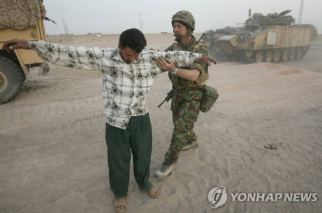 지난 2003년 이라크전 당시 영국 병사에게 몸수색을 당하는 이라크인 [로이터 연합뉴스 자료사진. 재판매 및 DB 금지]