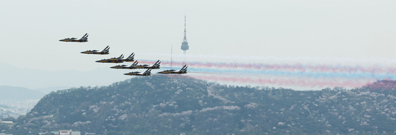 The Black Eagles, the Korean Air Force’s demonstration team, files over Seoul to celebrate the start of the cherry blossom festival in Yeouido, Seoul. The festival officially kicked off Tuesday and will run through Sunday. However, due to the unseasonably warm spring, around 500,000 people a day flocked to Yeouido's cherry blossoms last weekend. Temperatures in Seoul usually peaks at 15 degrees Celsius (59 degrees Fahrenheit) this time of year. However, temperatures have recently risen to 27 degrees Celsius, usually seen in early June. [YONHAP]