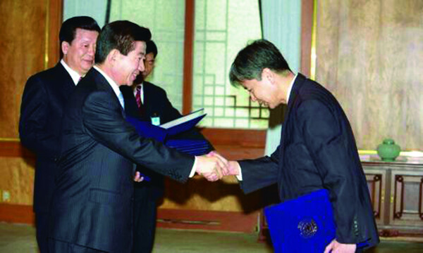 2003년 2월25일 취임식 직후 청와대에 입성한 노무현(왼쪽) 대통령은 이정우(오른쪽) 정책실장을 비롯 수석보좌관들에게 임명장을 수여하며 집무를 시작했다. 노무현사료관