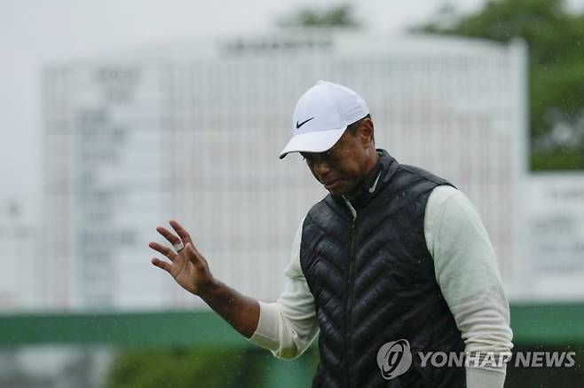 Tiger Woods waves after his weather delayed second round of the Masters golf tournament at Augusta National Golf Club on Saturday, April 8, 2023, in Augusta, Ga. (AP Photo/Charlie Riedel)