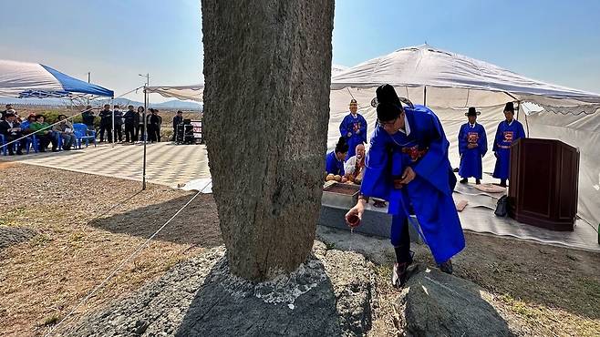 지난 3일 충남 서산시 부석면 검은여에서 거행된 검은여제에서 제관들이 검은여부석 선돌에 제주를 뿌리고 있다. 송인걸 기자