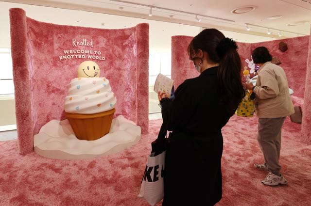 서울 송파구 롯데월드몰에 오픈한 도넛 브랜드 노티드의 플래그십 스토어를 찾은 시민들이 컵케이크 모형과 함께 인증샷을 남길 수 있는 포토존을 둘러보고 있다. 연합뉴스