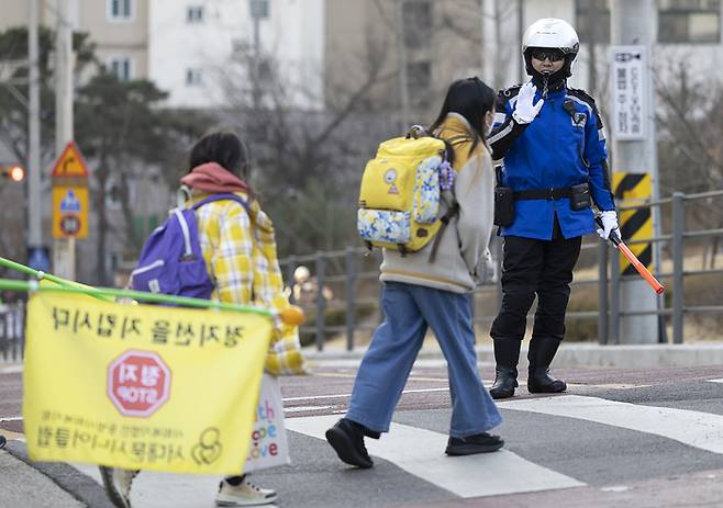 지난달 3일 오전 서울 서대문구 연가초등학교 앞에서 경찰이 ‘새 학기 등교 스쿨존 특별단속’중 학생과 인사를 하고 있다. 연합뉴스 자료사진