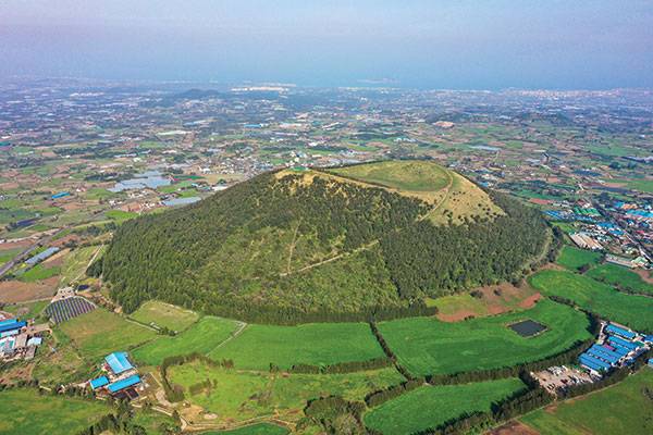 하늘에서 본 금오름. 비스듬히 사선으로 오르는 포장도가 보인다.