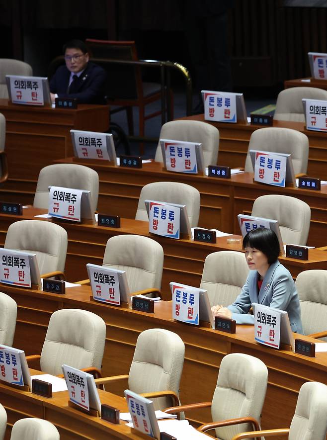 27일 국회 본회의에서 간호법 표결 전 최연숙 국민의힘 의원이 자리를 지키고 있다. 다른 국민의힘 의원들은 퇴장했다. 왼쪽 위 이종성 의원이 반대 토론을 위해 남아있다. [연합]