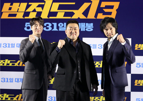 From left, actors Lee Joon-hyuk, Don Lee, and Munetaka Aoki pose for a photo during the press conference for ″The Roundup: No Way Out″ at Megabox COEX in Gangnam District, southern Seoul, on Tuesday. [NEWS1]