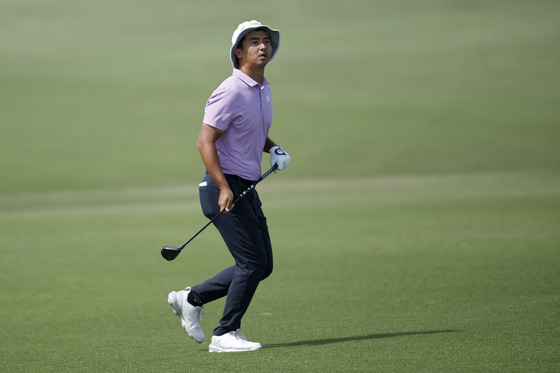 Zecheng Dou follows his shot on the 18th hole during the third round of the AT&T Byron Nelson at TPC Craig Ranch on Saturday in McKinney, Texas. [GETTY IMAGES]