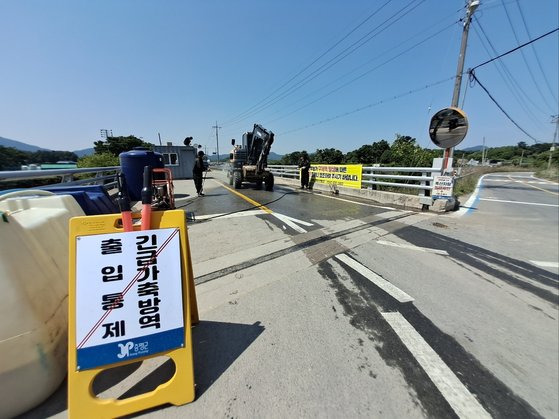 15일 충북 증평군 도안면 마을 입구에서 방역 요원들이 자동차를 소독하고 있다. 최종권 기자