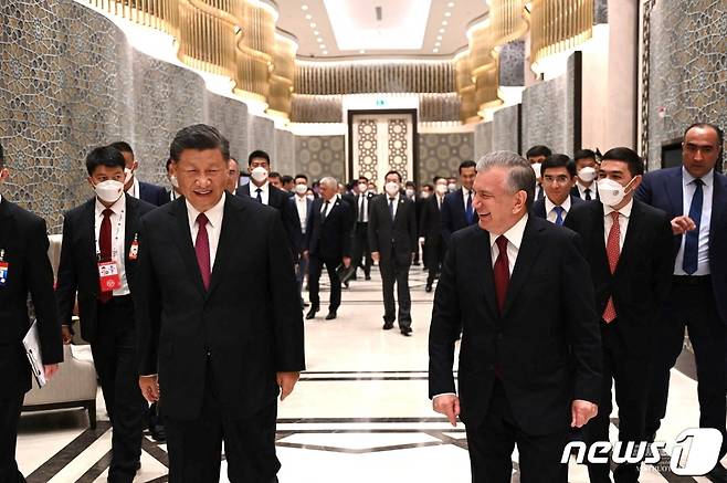 상하이협력기구(SCO) 정상회의 참석 계기 중앙아시아를 순방 중인 시진핑 중국 국가주석이 지난해 9월15일(현지시간) 사마르칸트에서 샵카트 미르지요예프 우즈베키스탄 대통령과 마스크를 벗은 채 대화하고 있다. 뒤로는 중국 측 수행원 전원이 마스크를 착용했으며, 우즈벡 측은 일부만 마스크를 착용한 모습이다. 2022. 9. 15. ⓒ 로이터=뉴스1 ⓒ News1 최서윤 기자