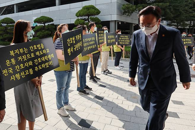 조규홍 보건복지부 장관이 16일 오후 서울 고려대학교 안암병원에서 현장 간담회에 참석하는 가운데 고려대 안암병원 간호사와 전국보건의료산업노동조합 조합원들이 윤석열 대통령의 간호법 제정안에 대한 법률안 거부권 행사를 규탄하며 손팻말을 들고 있다. 연합뉴스