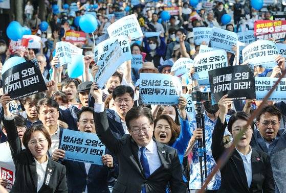 더불어민주당 이재명 대표가 20일 오후 서울 중구 한국프레스센터 인근 세종대로에서 열린 '일본 방사성 오염수 해양투기 저지 전국 행동의 날'에 참석해 서울광장 방향으로 행진하며 구호를 외치고 있다. 왼쪽은 정의당 강은미 의원, 오른쪽은 진보당 윤희숙 상임대표. 연합뉴스