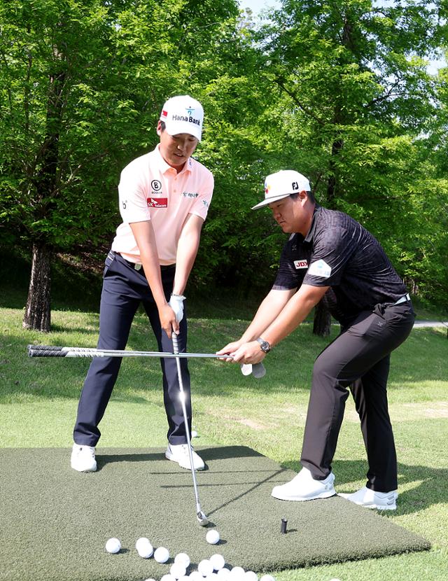 이승민(왼쪽)이 10일 경기 여주시 페럼클럽에서 열린 PGA 코리안투어 우리금융 챔피언십 개막 전날 PGA에서 활약하고 있는 세계 19위 임성재에게 개인 레슨을 받고 있다. KPGA 제공