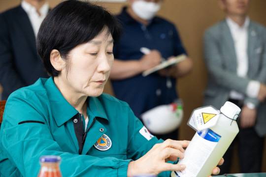 한화진 환경부 장관이 26일 서울 강서구 서울교통공사 방화차량사업소에서 방역 작업 시 사용하는 소독제가 환경부 승인 제품인지 확인하고 있다. [환경부 제공]