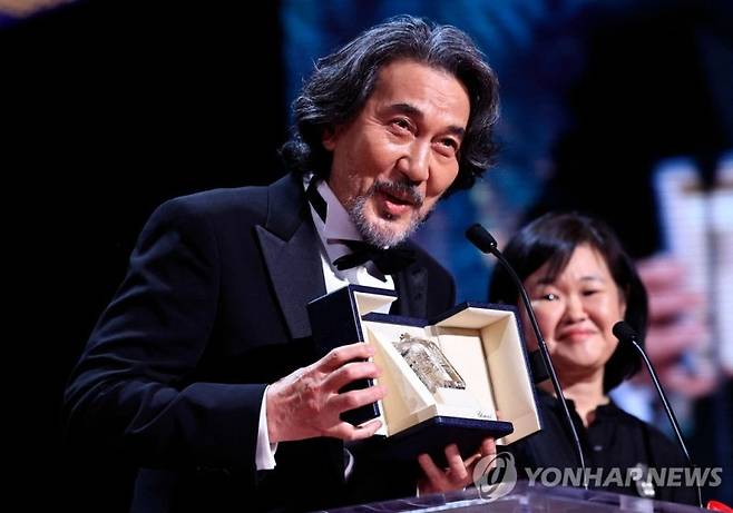 Japanese actor Koji Yakusho delievrs a speech on stage after he received the Best Actor Prize for his part in the film "Perfect Days" during the closing ceremony of the 76th edition of the Cannes Film Festival in Cannes, southern France, on May 27, 2023. (Photo by Valery HACHE / AFP)