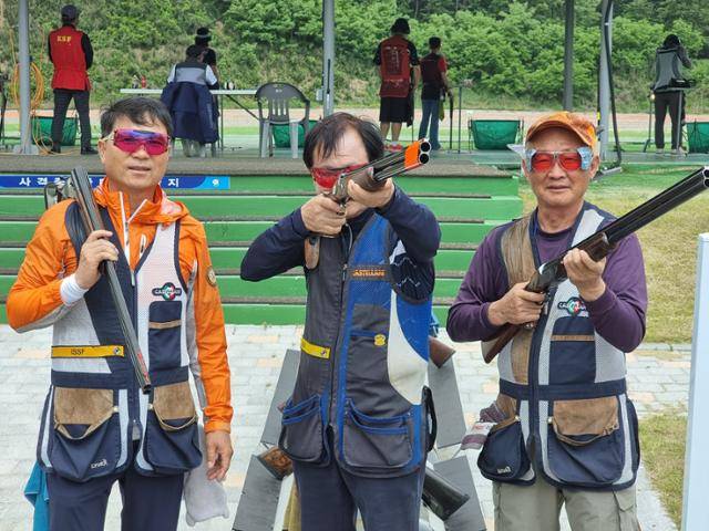 생활체육 사격대회에 출전한 김영남(왼쪽부터)씨, 문해옥 대한사격연맹 생활체육위원장, 오덕영씨가 21일 충북 청주종합사격장에서 사격 자세를 취하고 있다. 청주=김지섭 기자