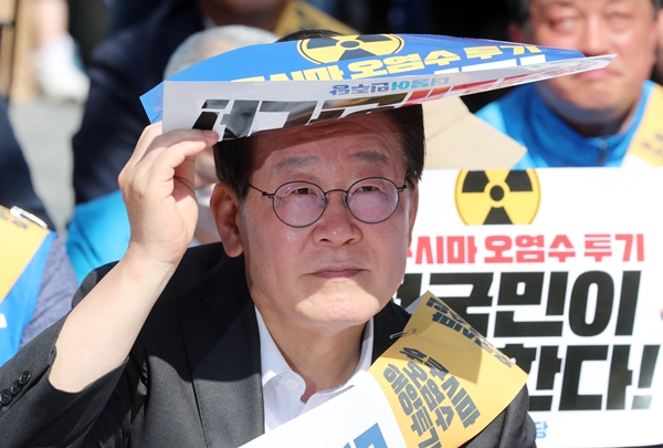 이재명 더불어민주당 대표가 3일 부산 부산진구 서면에서 열린 후쿠시마 원전 오염수 해양투기 규탄대회에 참석해 손팻말로 햇빛을 가리고 있다. 뉴시스