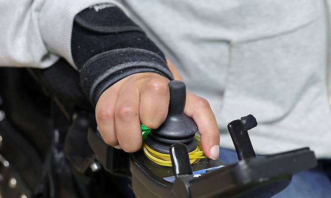 손가락도 움직이기 힘든 임 화가는 어깨 힘으로 전동 휠체어를 조작한다.