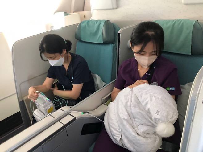 순천향대부천병원 의료진이 괌에서 출발해 국내로 들어오는 비행기 안에서 미숙아 A양을 돌보고 있다. /사진=순천향대부천병원