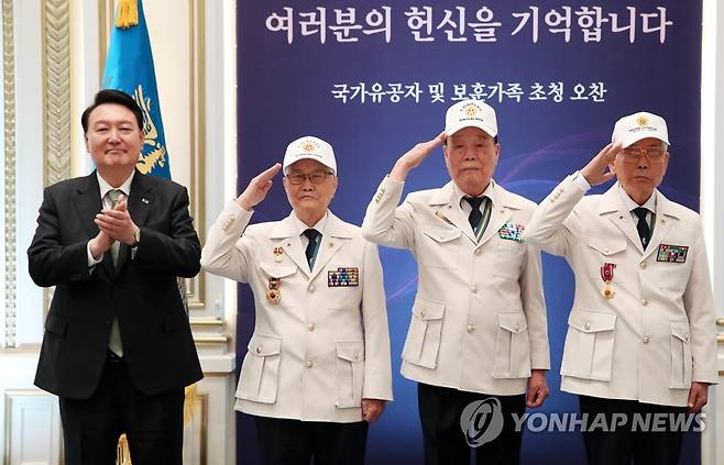 윤 대통령, '영웅의 제복' 착용한 참석자들과 기념촬영 (서울=연합뉴스) 진성철 기자 = 윤석열 대통령이 14일 청와대 영빈관에서 열린 국가유공자 및 보훈가족 초청 오찬에서 대한민국6.25참전유공자회 손희원 회장(왼쪽 두번째부터), 김창석. 이하영 이사에게 '영웅의 제복'을 직접 입혀준 뒤 기념촬영을 하고 있다. 2023.6.14 [대통령실통신사진기자단] zjin@yna.co.kr