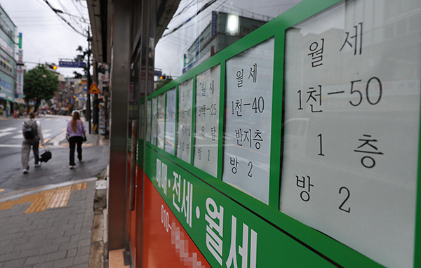 Monthly rent advertisements are posted on a window at a real estate in Seoul on the afternoon of June 21.  [Photo by Yonhap]