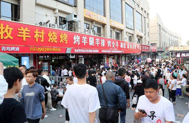 5월 중국 산둥성 쯔보시를 찾은 관광객들이 꼬치구이를 먹기 위해 상점을 둘러보고 있다. 최근 중국에서는 '쯔보 꼬치구이'가 열풍을 일으키며 지역 경제 활성화의 롤모델로 떠올랐다. 쯔보=AFP 연합뉴스