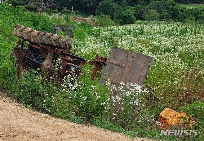 [제천=뉴시스] 이도근 기자= 4일 오후 12시20분께 충북 제천시 수산면 능강리 한 농로에서 A(25)씨가 자신이 몰던 트랙터에 깔려 숨진 채 발견됐다. 사고 현장의 쓰러진 트랙터 모습. (사진=제천소방서 제공) 2023.7.4. photo@newsis.com *재판매 및 DB 금지