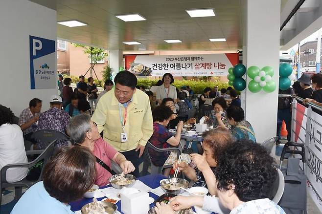 [부산=뉴시스] 오은택 남구청장(가운데)이 문현복지관에서 진행된 삼계탕 나눔 행사에서 어르신들과 소통하고 있다. (사진=남구청 제공) *재판매 및 DB 금지