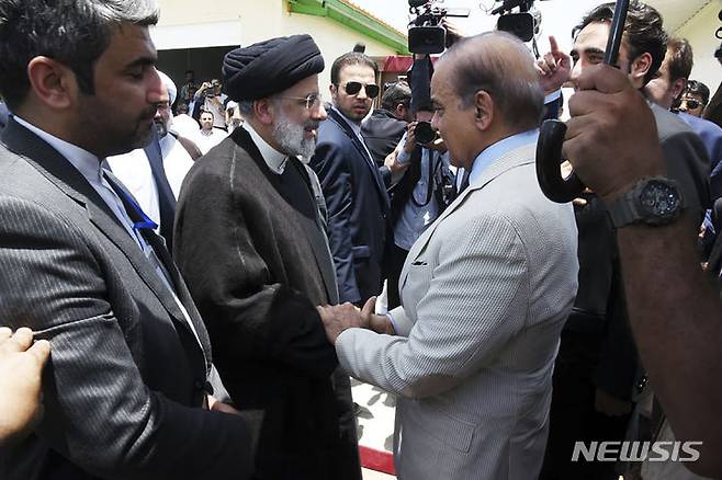 [피신( 파키스탄-이란 국경초소)=AP/뉴시스] 파키스탄 총리실이 배포한 2023년 5월 18일 파키스탄-이란 국경지대인 푸신과 만드 사이의 국경 시장에서 만난 에브라힘 라이시 이란 대통령과 샤바즈 샤리프 파키스탄 총리의 사진.  두 나라는 이 날 이후 국경지대의 안보와 이슬람 테러에 대한 공동 대응에 협력을 약속해왔다. 2023.07.16.