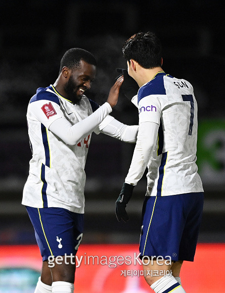 HIGH WYCOMBE, ENGLAND - JANUARY 25: Tanguy Ndombele of Tottenham Hotspur celebrates after scoring their sides third goal with team mate Son Heung-Min during The Emirates FA Cup Fourth Round match between Wycombe Wanderers and Tottenham Hotspur at Adams Park on January 25, 2021 in High Wycombe, England. Sporting stadiums around the UK remain under strict restrictions due to the Coronavirus Pandemic as Government social distancing laws prohibit fans inside venues resulting in games being played behind closed doors. (Photo by Shaun Botterill/Getty Images)