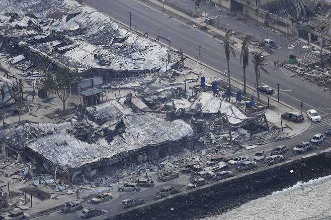 Wildfire wreckage is shown Thursday, Aug. 10, 2023, in Lahaina, Hawaii. The search of the wildfire wreckage on the Hawaiian island of Maui on Thursday revealed a wasteland of burned out homes and obliterated communities as firefighters battled the stubborn blaze making it the deadliest in the U.S. in recent years. (AP Photo/Rick Bowmer)