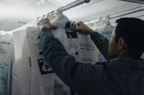 A Washswat employee organizes laundry clothing. [SCREEN CAPTURE]