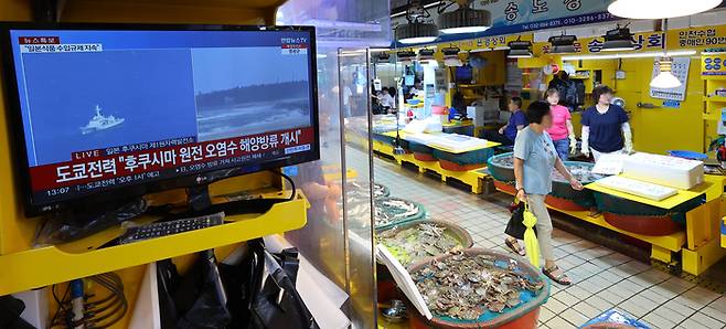 일본이 후쿠시마 오염수 방류를 시작한 24일 오후 인천시 중구 인천종합어시장에 후쿠시마 원전 오염수 해양방류 개시 뉴스가 나오고 있다. [출처 : 연합뉴스]