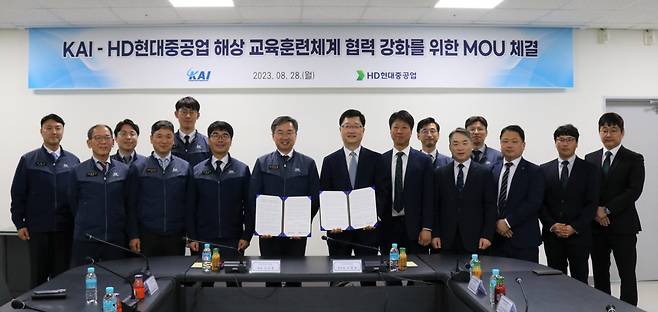 Officials from Korea Aerospace Industries and HD Hyundai Heavy Industries sign a memorandum of understanding to develop maritime training systems at KAI's headquarters in Sacheon, South Gyeongsang Province, Monday. (KAI)