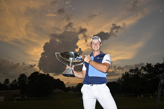 Viktor Hovland poses with the FedEx Cup Trophy after putting in to win on the 18th green during the final round of the Tour Championship at East Lake Golf Club in Atlanta, Georgia on Sunday. [GETTY IMAGES]