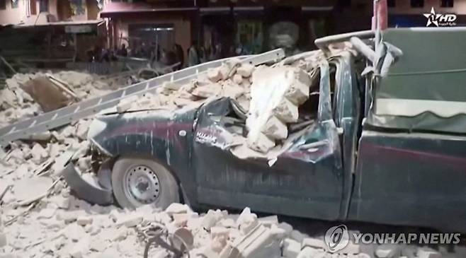 View of a damaged car and debris from the earthquake in Marrakech, Morocco September 9, 2023 in this screen grab taken from a video. Al Oula TV/Handout via REUTERS THIS IMAGE HAS BEEN SUPPLIED BY A THIRD PARTY. NO RESALES. NO ARCHIVES. MANDATORY CREDIT. MOROCCO OUT. NO COMMERCIAL OR EDITORIAL SALES IN MOROCCO