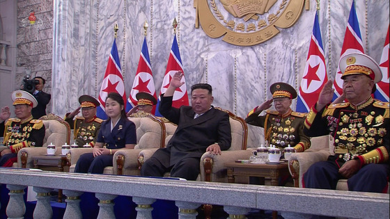 North Korean leader Kim Jong-0un, center, with daughter Kim Ju-ae attends the parade commemorating the 75th anniversary of the founding of North Korea at the Kim Il Sung Square on Saturday. [KOREAN CENTRAL NEWS AGENCY]