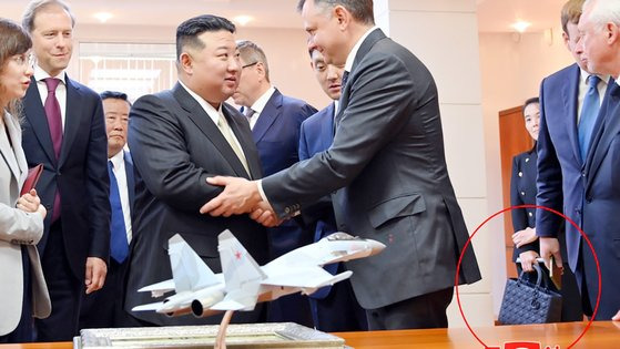 김정은 북한 국무위원장이 지난 15일 러시아 하바롭스크주 콤소몰스크나아무레시의 유리 가가린 전투기 공장을 방문한 현장에 동행한 김여정 노동당 부부장이 프랑스 고가 핸드백으로 추정되는 가방(붉은 원)을 들고 있다. 조선중앙통신=연합뉴스