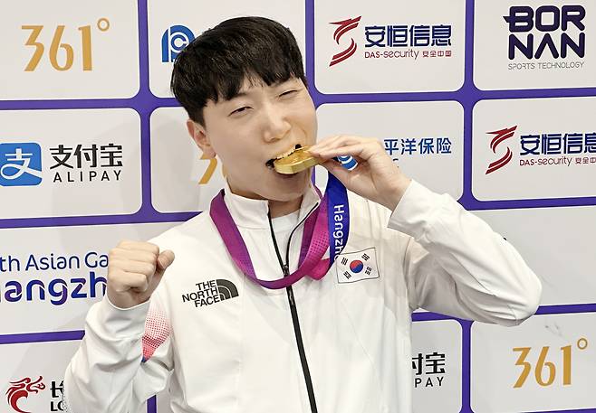 28일 중국 항저우 e스포츠센터에서 열린 2022 항저우 아시안게임(AG) 스트리트 파이터 V 결승전에서 대만의 샹여우린을 세트 점수 4-3으로 물리치고 금메달을 획득한 뒤 공동취재구역(믹스트존)에서 취재진을 향해 포즈를 취하고 있다. [연합]