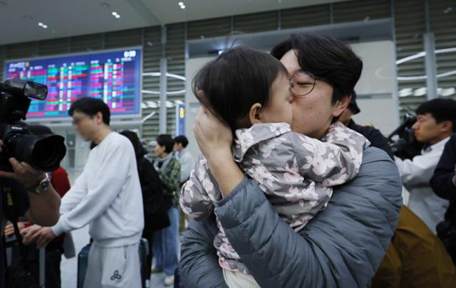 한 시민이 11일 오전 인천국제공항 제2터미널에서 이스라엘에서 돌아온 딸에게 입을 맞추고 있다. 뉴스1