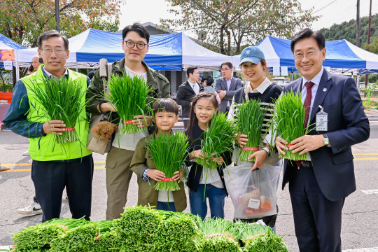 지난 7일 ‘양평부추축제’가 열린 경기 양평군 양동면 현장에서  전진선(오른쪽 첫 번째) 양평군수가 관람객들과 부추단을 들고 즐거워하고 있다. 양평군청 제공