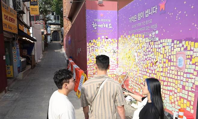 이태원 참사 1주기를 앞둔 18일 서울 용산구 이태원 참사 사고현장에서 시민들이 추모메세지를 보고 있다.