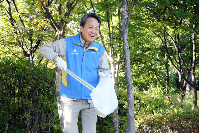 진옥동 신한금융그룹 회장이 20일 서울 남산에서 그룹 관계사 최고경영자들과 함께 ‘남산 둘레길 플로깅 활동’에 참가해 쓰레기를 줍고 있다. 사진 제공=신한금융