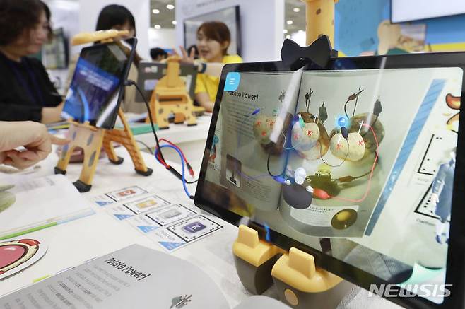 [서울=뉴시스] 최동준 기자 = 지난달 21일 서울 강남구 코엑스에서 열린 2023 에듀테크 코리아 페어에서 업체 관계자가 AR 영유아 학습 도구 제품 설명을 듣고 있다. 2023.09.21. photocdj@newsis.com